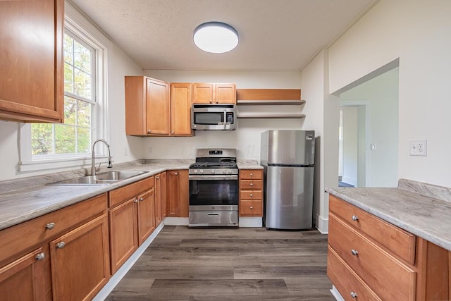 kitchen featuring a textured ceiling, dark hardwood / wood-style flooring, sink, and appliances with stainless steel finishes