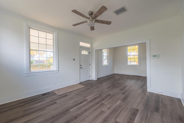 foyer entrance with a textured ceiling, ceiling fan, and dark wood-type flooring