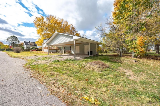 exterior space with a carport and a front yard