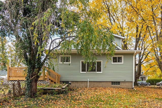 view of property exterior with a wooden deck