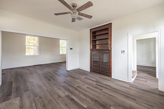 unfurnished living room with dark hardwood / wood-style flooring, a textured ceiling, built in features, and ceiling fan