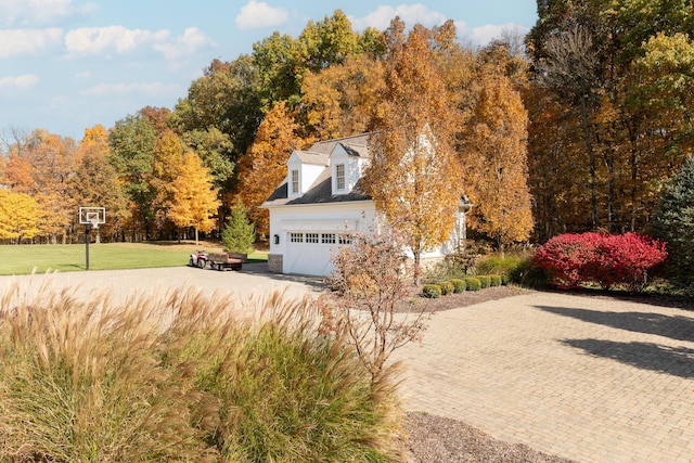 exterior space with a yard and a garage