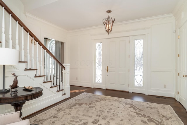 entrance foyer featuring dark hardwood / wood-style floors and ornamental molding