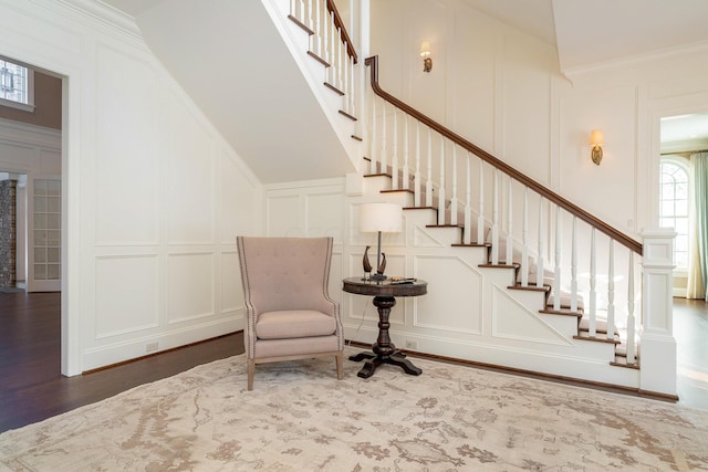 interior space with ornamental molding and dark hardwood / wood-style flooring