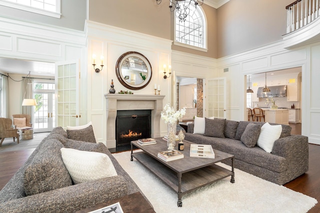 living room with french doors, a high ceiling, and dark hardwood / wood-style flooring