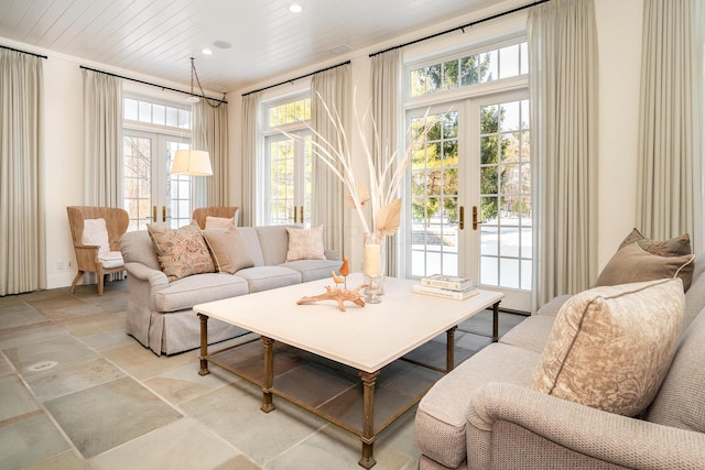 sunroom / solarium featuring french doors