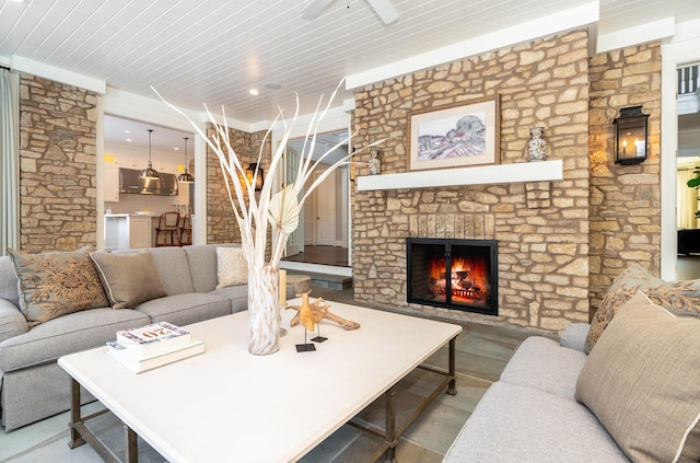 living room with a stone fireplace