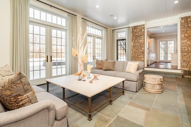 living room featuring french doors, a healthy amount of sunlight, and ornamental molding