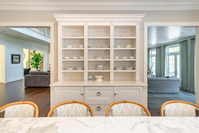 interior space featuring built in features, ornamental molding, and dark hardwood / wood-style floors