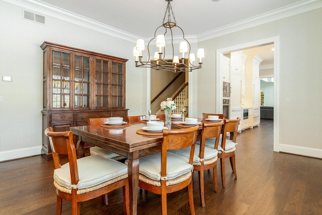 dining space with crown molding, dark wood-type flooring, and a notable chandelier