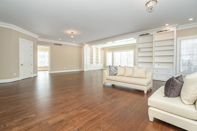 living room with dark wood-type flooring, crown molding, and a healthy amount of sunlight