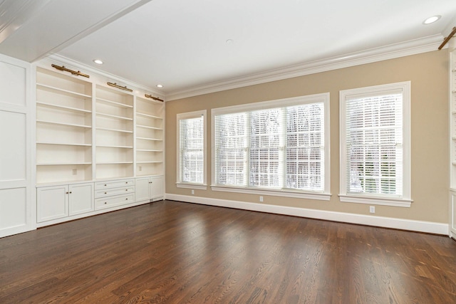 unfurnished room with built in shelves, dark wood-type flooring, and crown molding