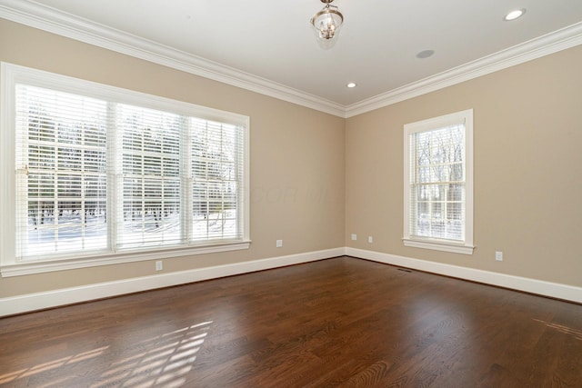 empty room with ornamental molding and dark hardwood / wood-style flooring