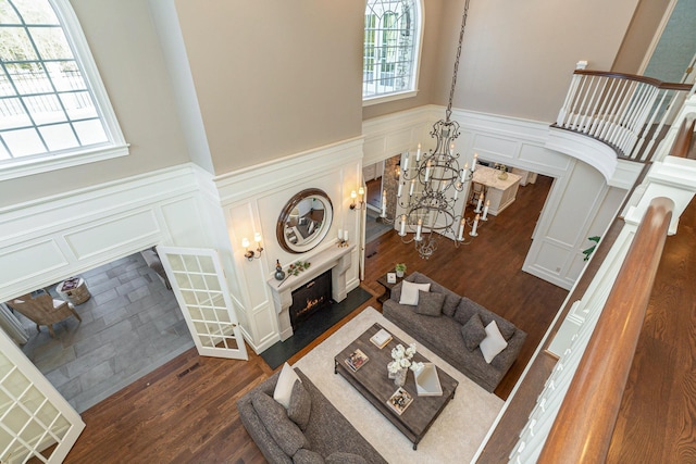 living room featuring dark hardwood / wood-style floors and an inviting chandelier