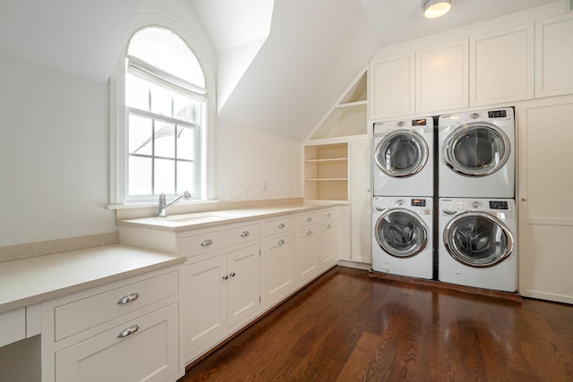 clothes washing area with sink, washing machine and clothes dryer, built in shelves, cabinets, and stacked washer / dryer