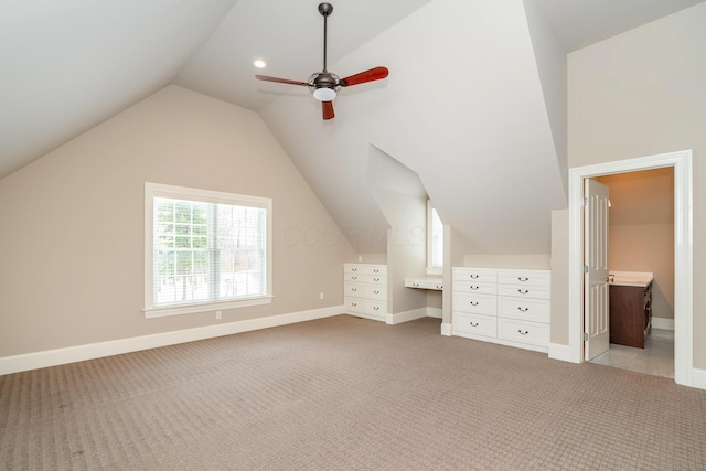 additional living space featuring ceiling fan, lofted ceiling, and light carpet