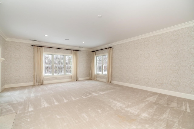 carpeted spare room featuring crown molding