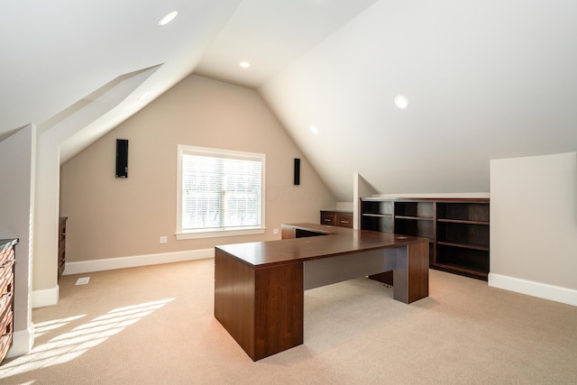 carpeted office with vaulted ceiling