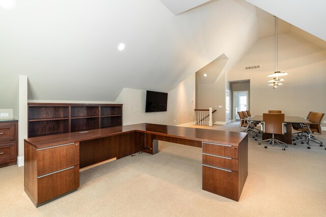 office space with lofted ceiling and light carpet