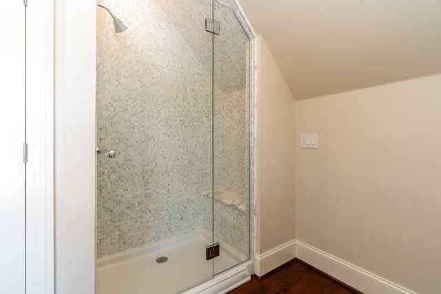 bathroom with hardwood / wood-style floors and an enclosed shower