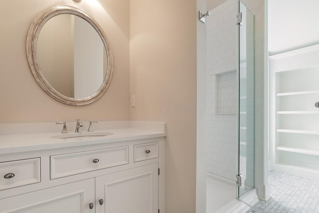 bathroom with vanity, a shower with door, and tile patterned flooring