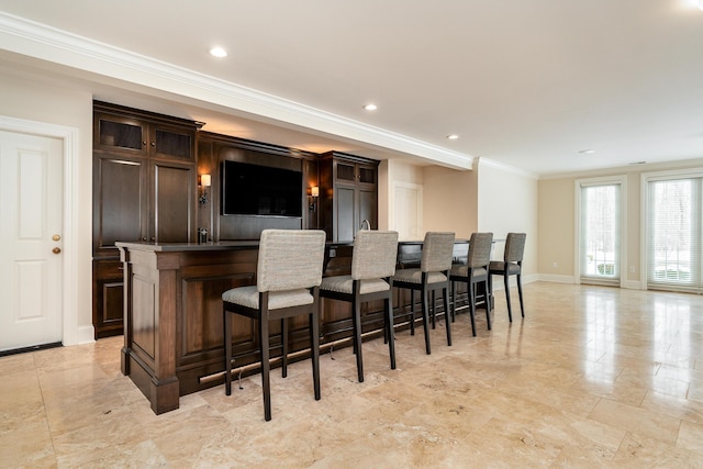 bar featuring crown molding and dark brown cabinets