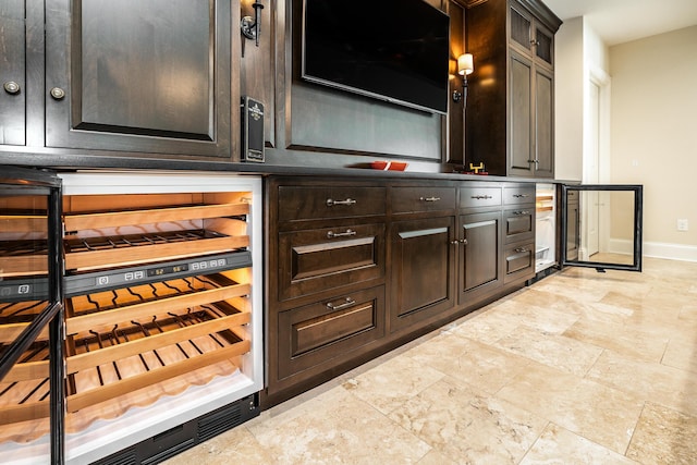 kitchen featuring beverage cooler and dark brown cabinets