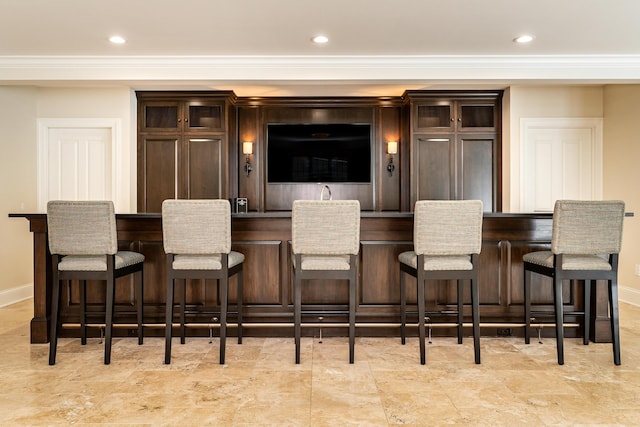 cinema room featuring indoor bar and crown molding