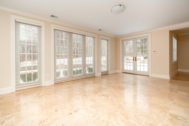 empty room with ornamental molding and french doors