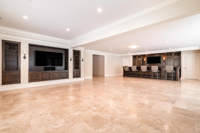 unfurnished living room featuring bar and crown molding