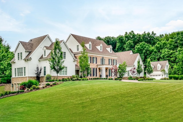 view of front facade with a garage and a front lawn