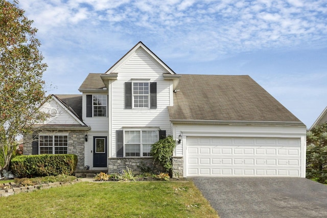 view of front of house featuring a garage and a front lawn