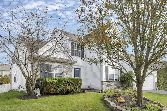 view of front of house featuring a front yard and a garage