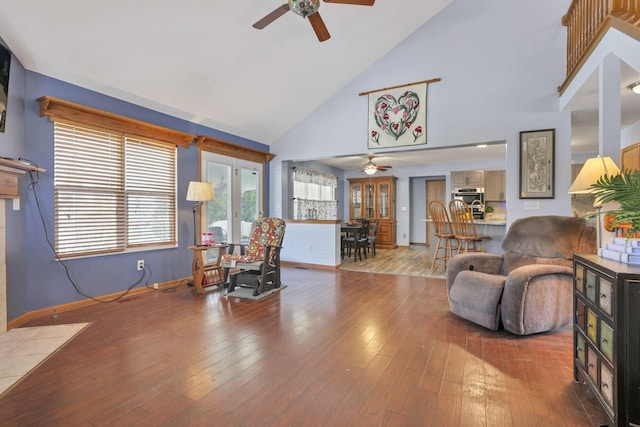 living room with ceiling fan, wood-type flooring, and high vaulted ceiling