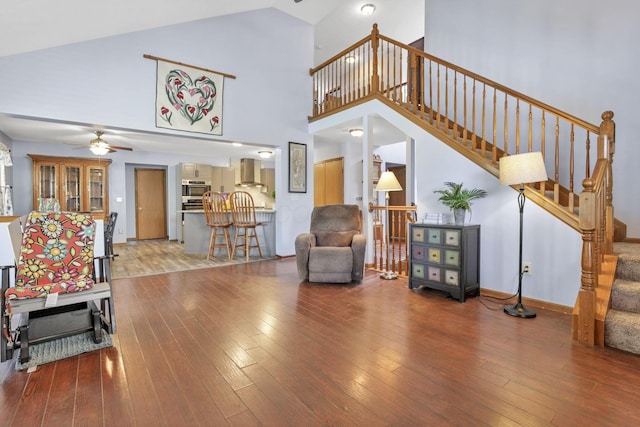 living room with ceiling fan, high vaulted ceiling, and hardwood / wood-style flooring