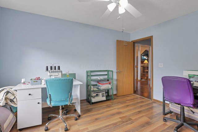 office area with ceiling fan and light hardwood / wood-style floors