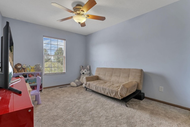 sitting room with ceiling fan and carpet floors