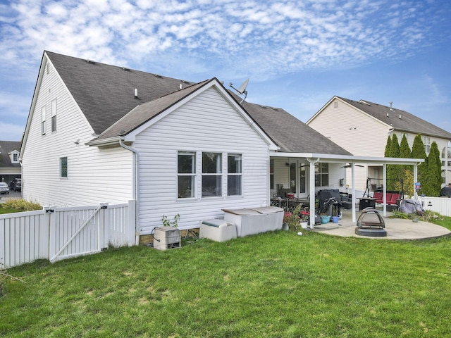 back of property featuring a yard, a patio, and ceiling fan