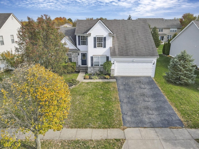 view of front of property with a garage and a front lawn