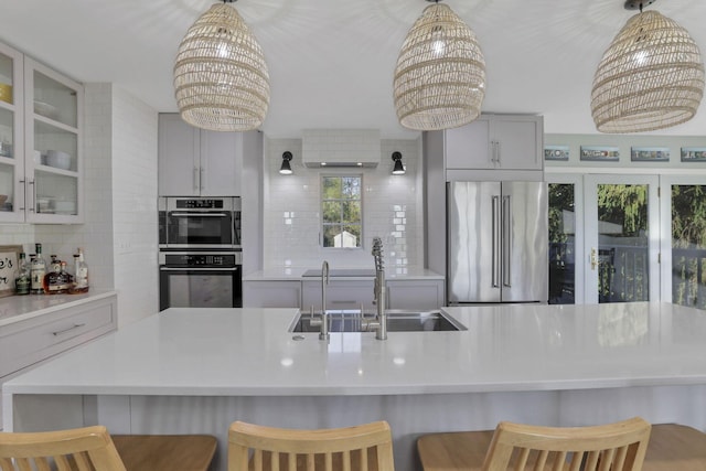 kitchen with stainless steel appliances, a kitchen bar, and a chandelier