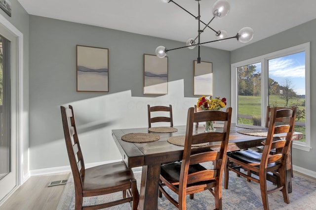 dining room featuring a chandelier and light hardwood / wood-style flooring