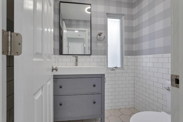 bathroom with vanity, toilet, and plenty of natural light