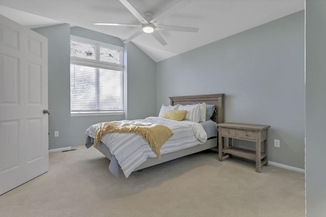 bedroom with light carpet, multiple windows, ceiling fan, and vaulted ceiling