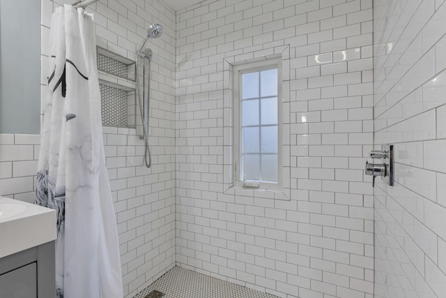 bathroom with vanity, tile walls, and a shower with curtain