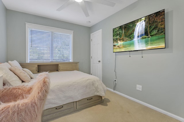 bedroom with light colored carpet and ceiling fan