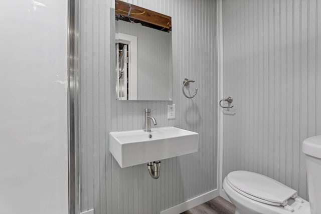 bathroom featuring toilet and hardwood / wood-style floors