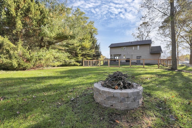 view of yard with an outdoor fire pit and a deck