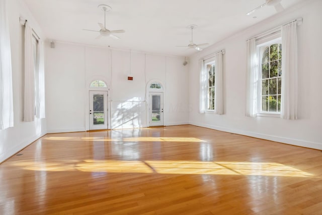 empty room with basketball court, ornamental molding, and light hardwood / wood-style flooring