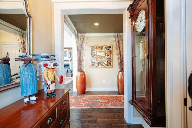 corridor featuring dark hardwood / wood-style floors and ornamental molding