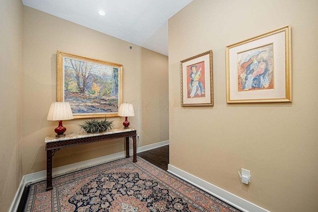 hallway with wood-type flooring